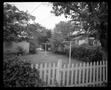 Photograph: [Clothesline behind a picket fence]