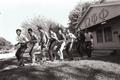 Photograph: [Line of dancing fraternity brothers]