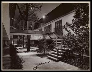 Primary view of object titled '[An apartment building with stairs and a patio walkway]'.