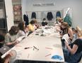 Photograph: [Graduate students practicing hand stitching]