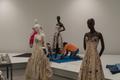 Primary view of [Janelle McCabe and Annette Becker placing a black and white evening dress on mannequin]
