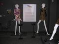 Primary view of [Exhibition text flanked by two mannequins]
