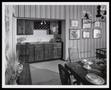 Photograph: [Interior of a dining room with striped wallpaper]