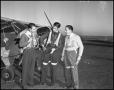 Thumbnail image of item number 1 in: '[Three Men Donning Flight Equipment]'.