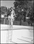Photograph: [Woman stands at the edge of a pool]