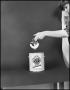 Photograph: [Woman pipping a pretzel in white paint]