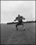 Photograph: [North Texas State University Jersey No. 62 Football Player Squat Rea…