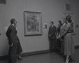 Photograph: [People standing around a museum painting]
