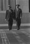 Photograph: [Two men walking across a road, 6]