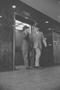 Photograph: [Two men leaving an elevator in Dallas, 7]
