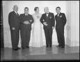 Photograph: [Woman standing with four men]