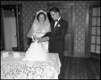 Photograph: [Bride and Groom with Wedding Cake]