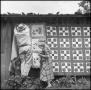 Photograph: [Woman and man at outdoor quilting bee]
