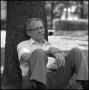 Photograph: [Dr. Wayne Adams sitting beneath a tree]
