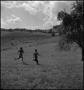 Photograph: [Children running across field]