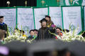 Primary view of [Student takes "selfie" at UNT Commencement]