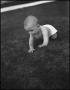 Photograph: [A baby crawling through a yard]