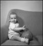 Photograph: [Baby holding a pumpkin in their lap]