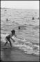 Photograph: [Boy playing on the shore with the waves]