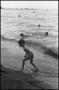 Photograph: [Young boy playing in the waves on the beach]