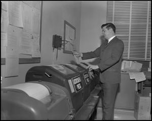 Primary view of object titled '[WBAP-TV Employee Reading From a Teleprinter]'.