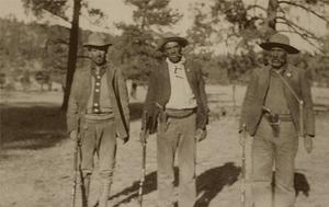 Primary view of object titled '[Photograph of three men holding rifles]'.