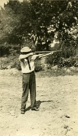 Primary view of object titled '[Photograph of a man pointing a rifle]'.