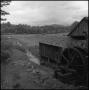 Photograph: [Watermill overlooking a field, 9]