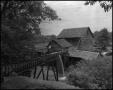 Photograph: [Man observing a watermill]