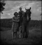 Photograph: [Children posing with a horse]