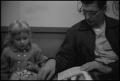 Photograph: [Photograph of a man and a young girl reading together]