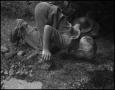 Photograph: [Young boy drinking water from the creek]
