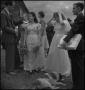 Photograph: [Ralph Richardson talking to the bride and groom]