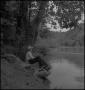 Photograph: [A man sitting while fishing]