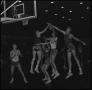 Photograph: [Basketball players block a shot]