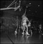 Photograph: [basketball players reaching for ball]