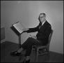 Photograph: [Maurice McAdow sitting in a chair, 5]
