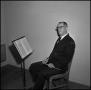Photograph: [Maurice McAdow sitting in a chair, 7]