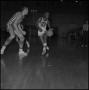 Photograph: [Oscar Miller dribbling a basketball]