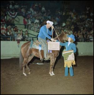 Primary view of object titled '[Man on horseback receives award from girl]'.