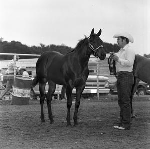 Primary view of object titled '[Man in a Stetson Holds a Horse]'.
