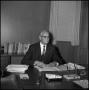 Photograph: [Dr. O. J. Curry sitting at desk]