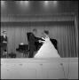 Photograph: [Woman in evening gown shakes hands with musician]