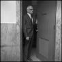 Photograph: [Dean A. Witt Blair holds open door]