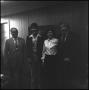 Photograph: [Four people standing together in hallway]