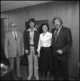 Photograph: [Four people standing in hallway]