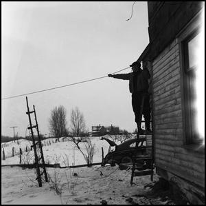 Primary view of object titled '[Man testing the strenghth of a wire]'.