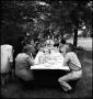 Photograph: [Large family dining outside together]