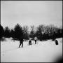 Photograph: [Three people skiing through the snow]