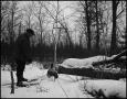 Photograph: [Man chopping logs in the snow, 2]